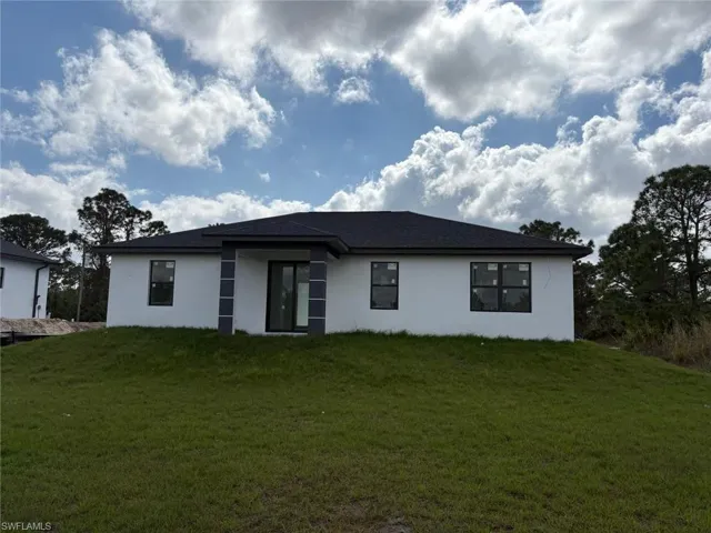 Rear view of house with a yard