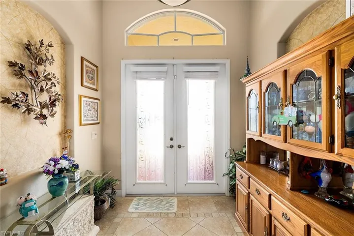 Entryway featuring french doors and light tile flooring