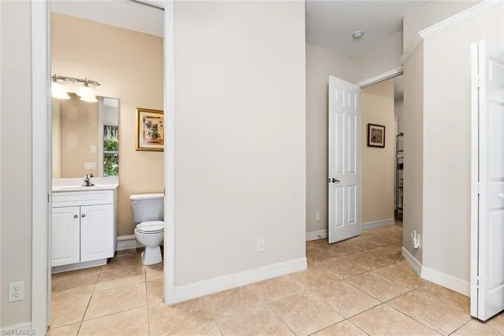 Bathroom featuring tile floors, toilet, and vanity