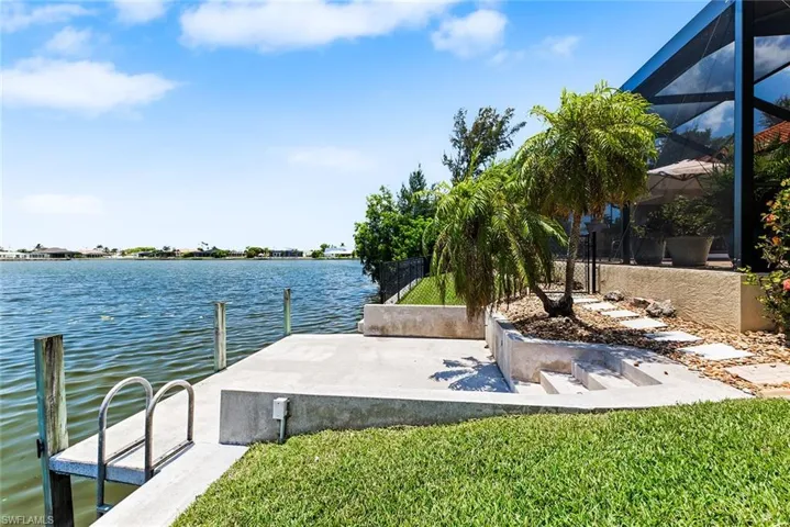 Dock area featuring glass enclosure and a water view