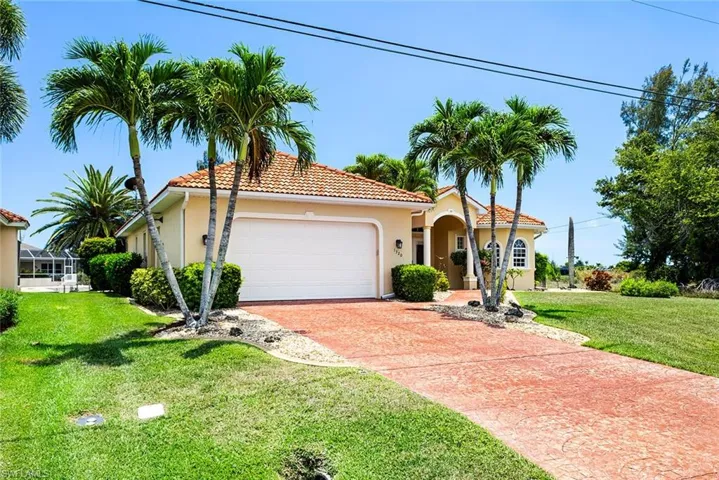 Mediterranean / spanish home featuring a front lawn and a garage