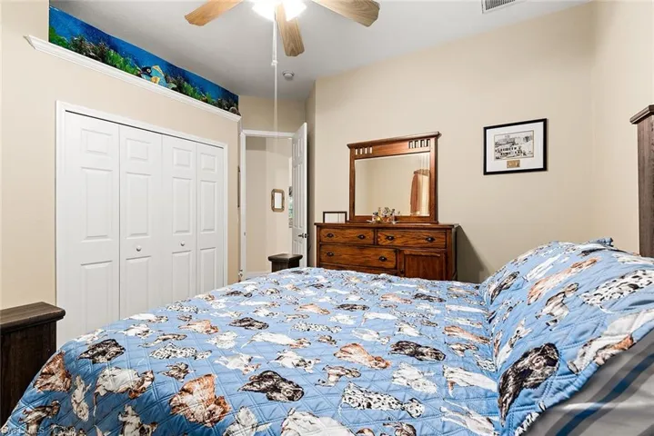 Bedroom featuring ceiling fan and a closet