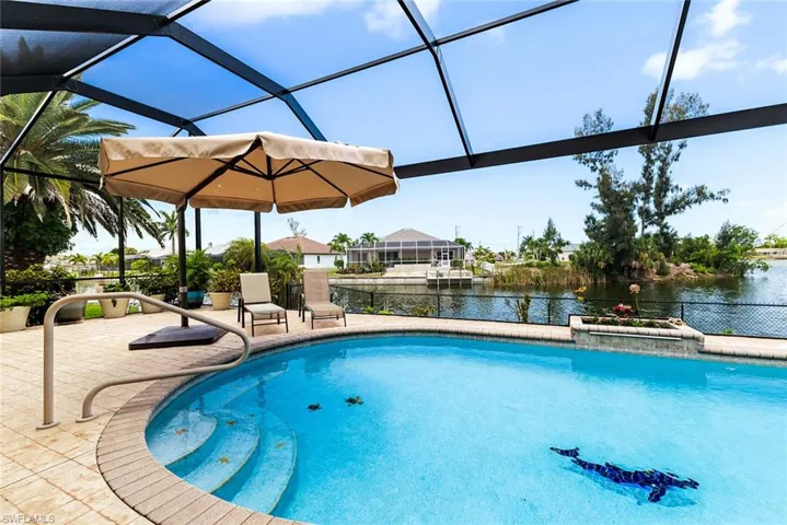 View of swimming pool with a patio, a lanai, and a water view
