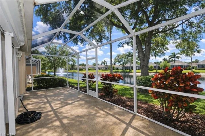Unfurnished sunroom featuring a water view, a residential view, and a patio