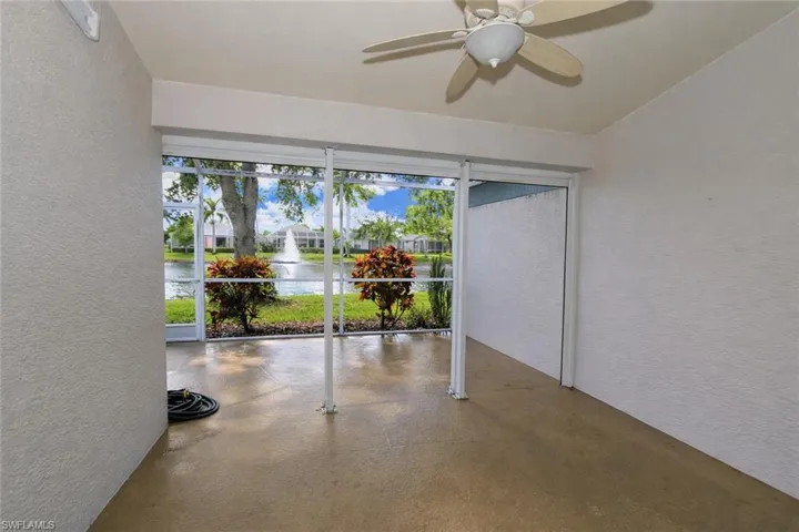 View of patio with a sunroom, ceiling fan, and a water view