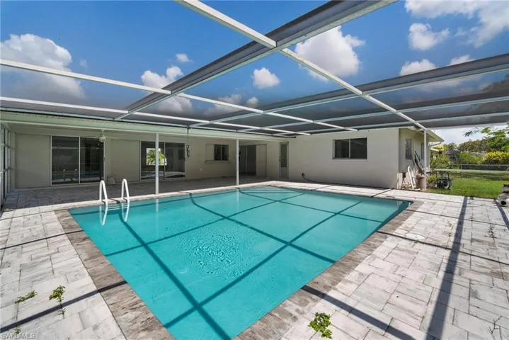 View of pool with a lanai and a patio area