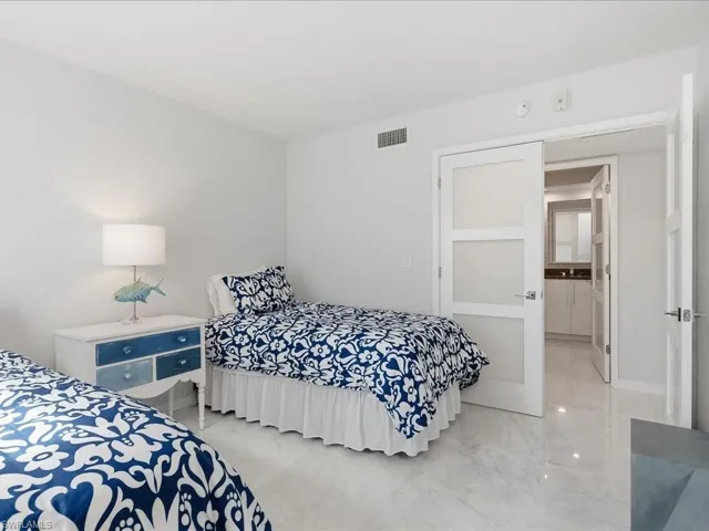 Bedroom with marble finish floors