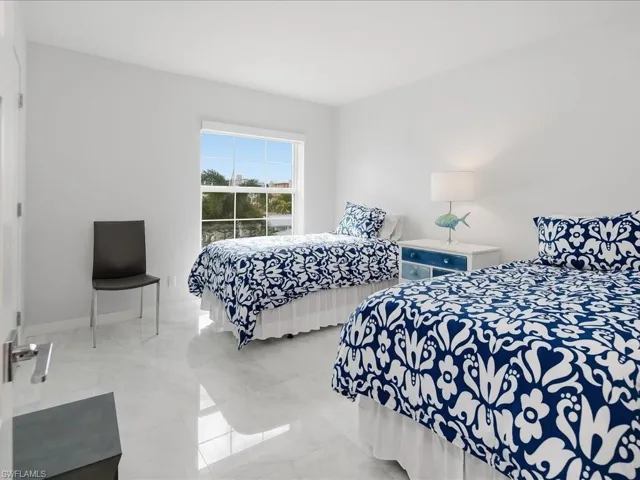 Bedroom with marble finish floors