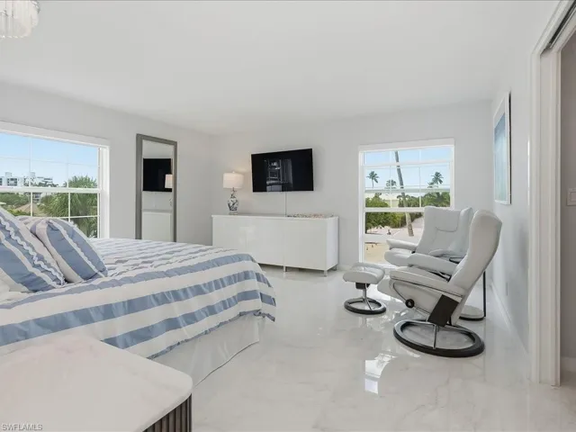 Bedroom with marble tiled flooring and baseboards