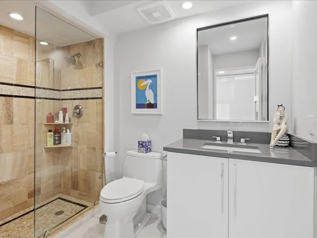 Full bathroom featuring vanity, recessed lighting, and walk in shower
