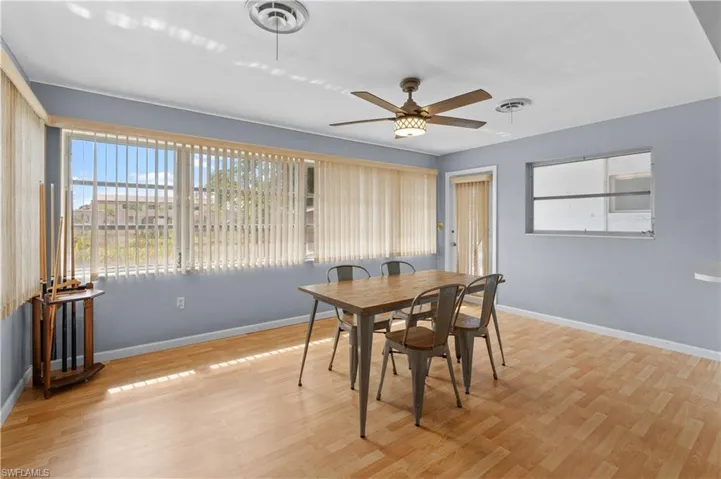 Den/ Flex room with light wood-type flooring and ceiling fan