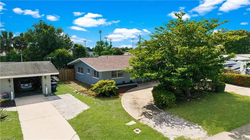 View of front of house featuring concrete driveway and a shingled roof