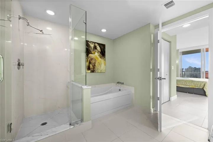 Ensuite bathroom with a garden tub, a marble finish shower, tile patterned floors, and recessed lighting