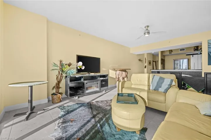 Living room with baseboards and a ceiling fan