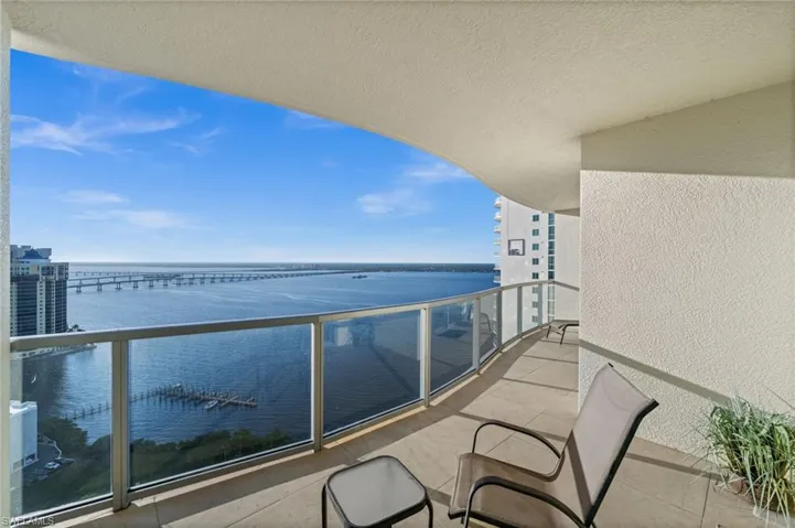 Balcony with a sunroom and a water view