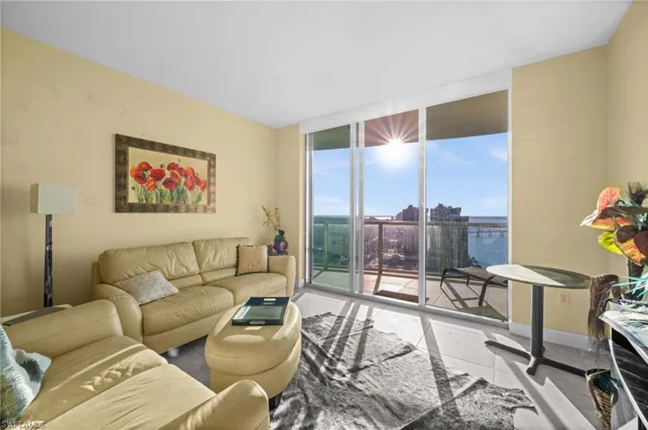 Living room with expansive windows and light tile patterned flooring