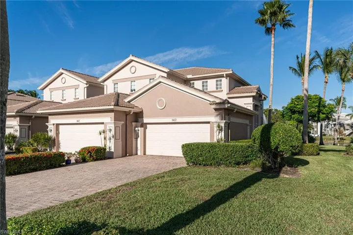Two-story residential structure featuring a stucco exterior and a tiled roof