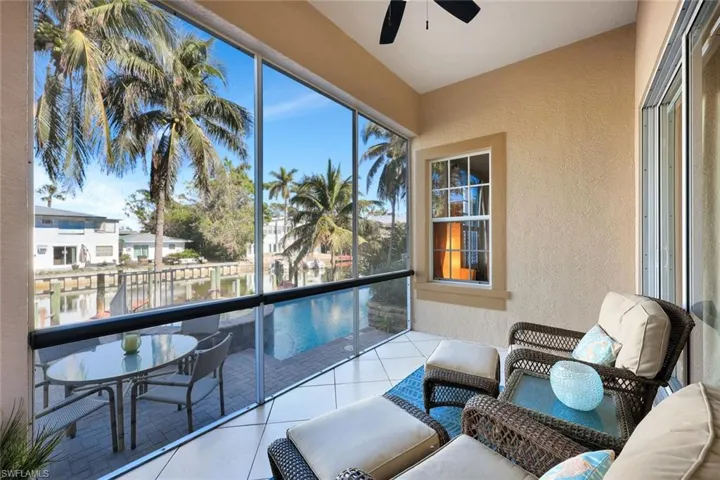 Screened lanai with a water view. Screen door to the brick paver deck.