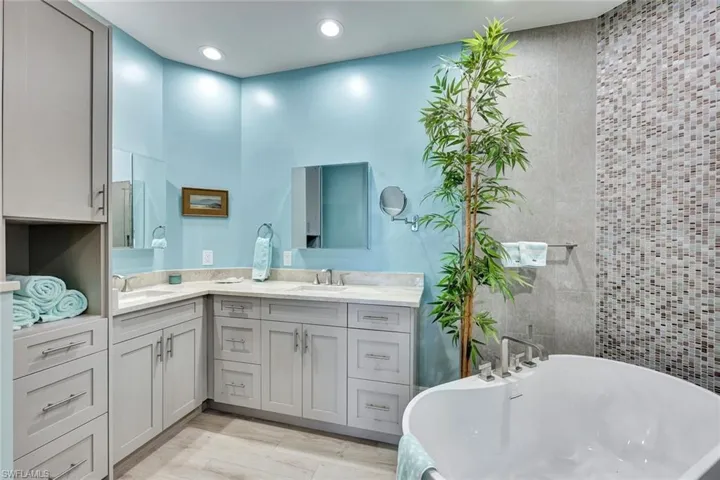Updated primary has added storage, free standing tub with tile feature wall.