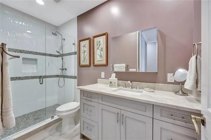 Shared guest bath. Updated vanity, granite, undermount sink, new tile in the shower and a glass shower enclosure.