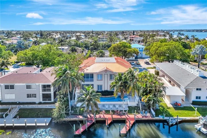 Birds eye view of property with a water view