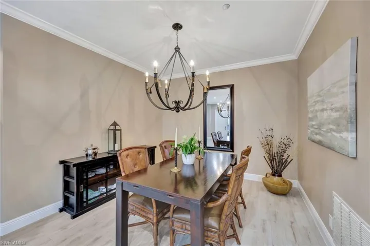 Dining space with an inviting chandelier, crown moldings.