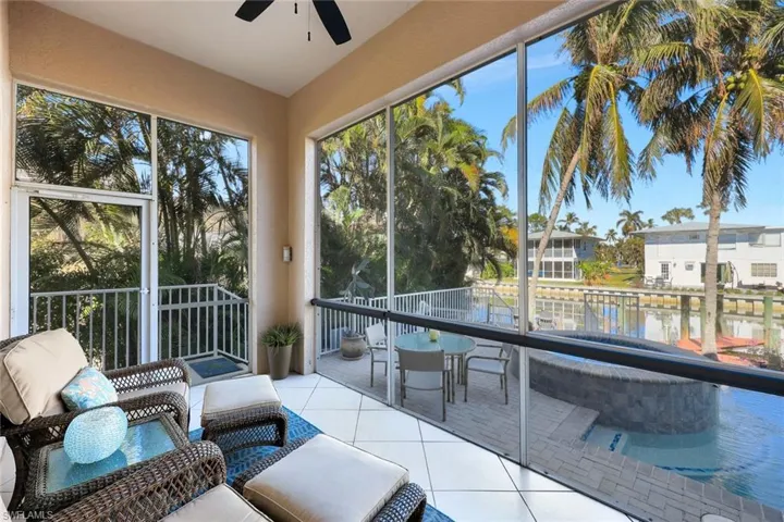 Screened porch with ceiling fan.