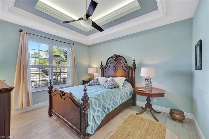 Spacious primary bedroom featuring a double tray ceiling