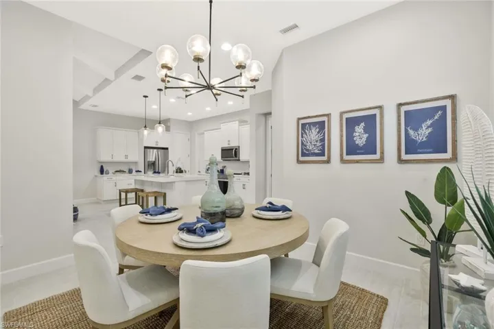 Dining room with a chandelier and recessed lighting