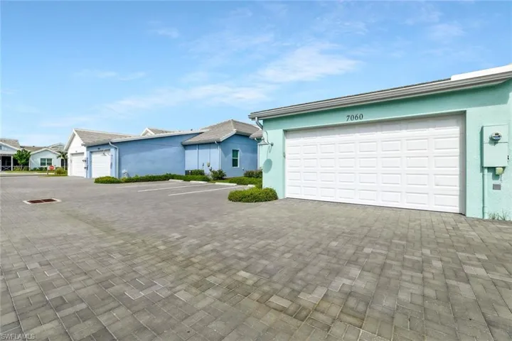 Single story home featuring stucco siding, decorative driveway, and a garage