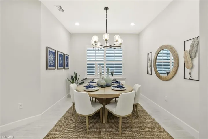 Dining space with a chandelier and recessed lighting