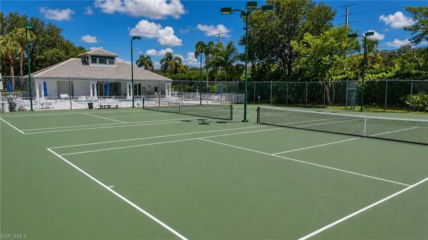 Two full-size tennis courts with perimeter fencing and court lighting