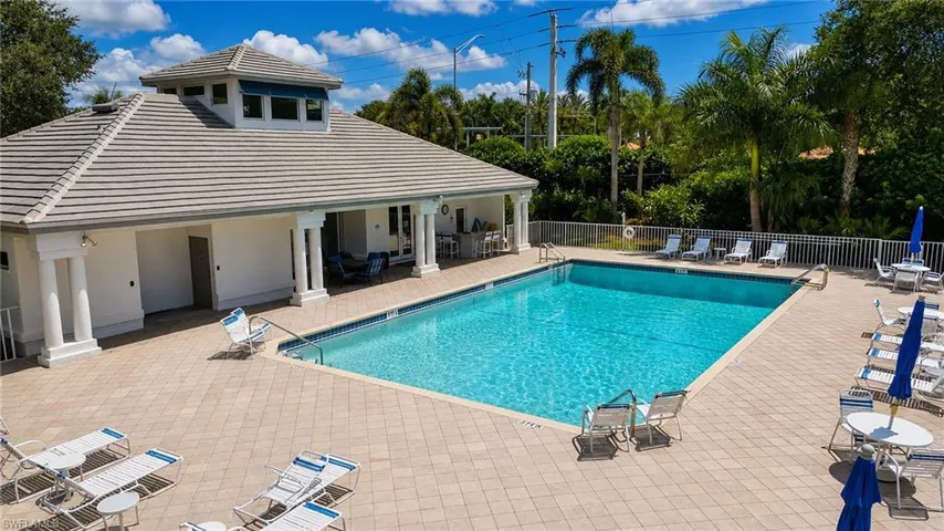 Large rectangular swimming pool surrounded by a paver deck