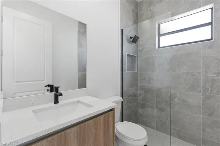 Full bath featuring vanity and walk in shower