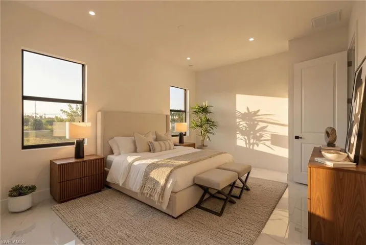 Bedroom with light marble finish floors and recessed lighting