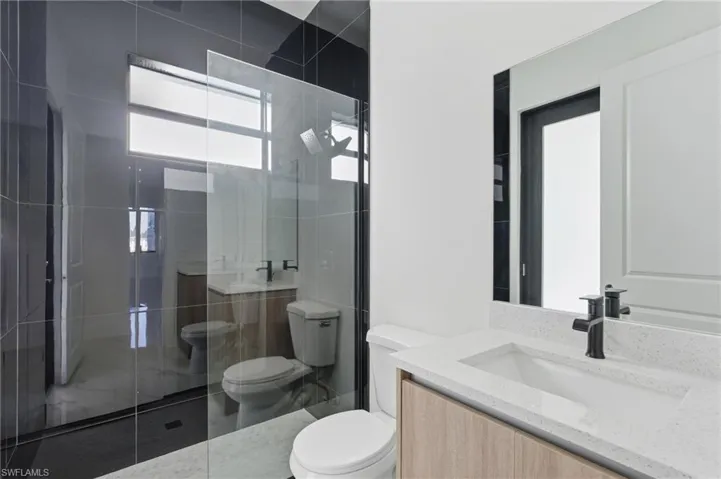 Full bathroom featuring vanity and a stall shower