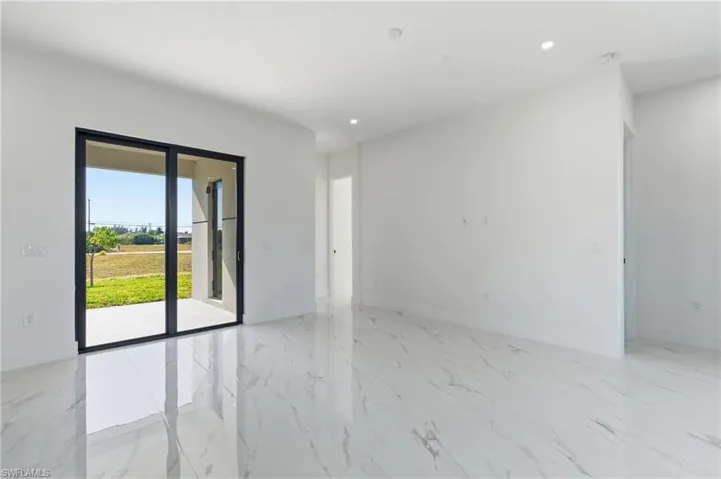 Unfurnished room featuring light marble finish floors and recessed lighting