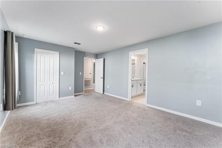 another vantage with views of the closet, hall, and en suite bath