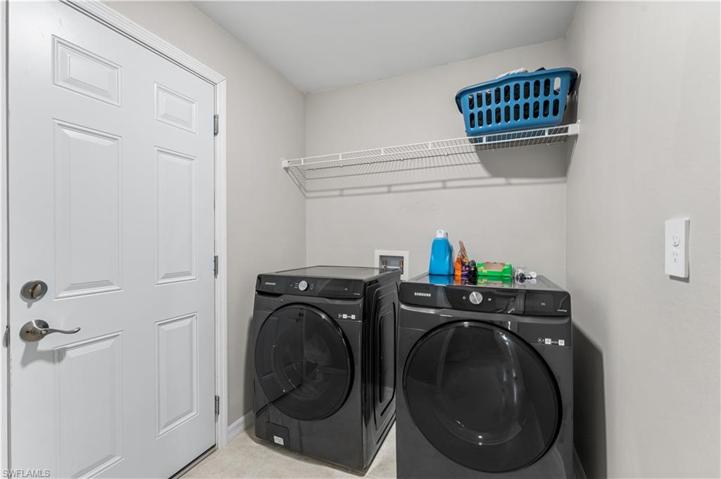 laundry with door to garage and door to foyer.  W/D convey!