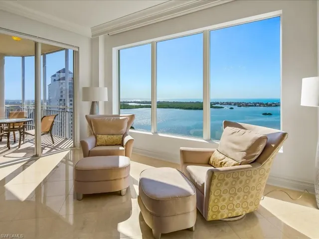 Sitting room featuring a water view, crown molding, and tile patterned floors