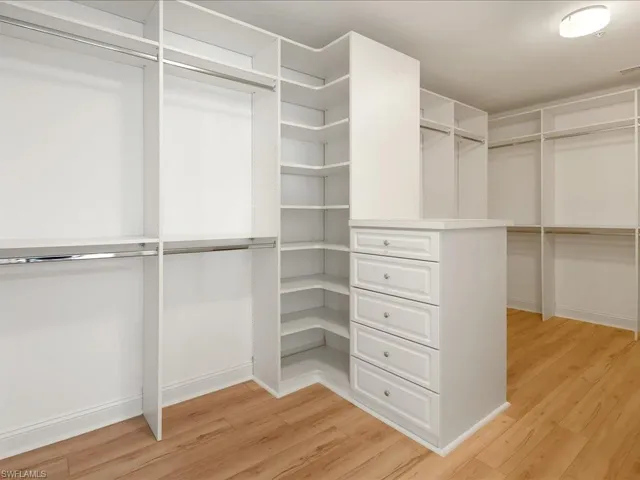 Walk in closet featuring light wood-style floors