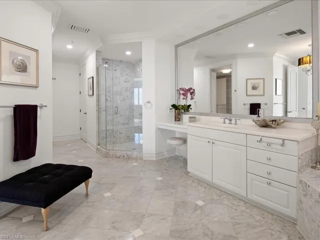 Bathroom with vanity, a marble finish shower, ornamental molding, and recessed lighting