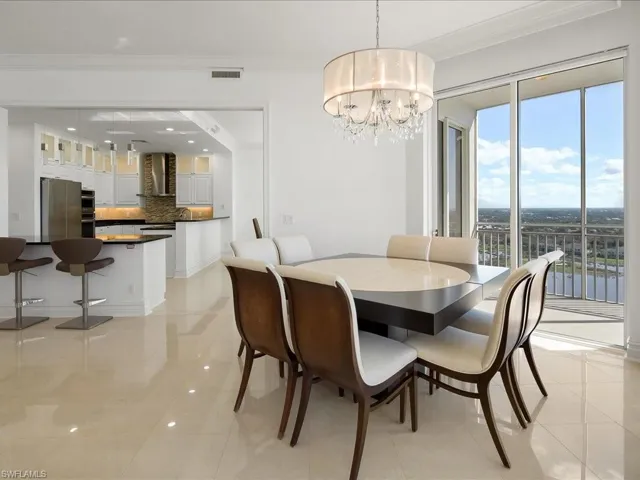 Dining space featuring crown molding and a chandelier