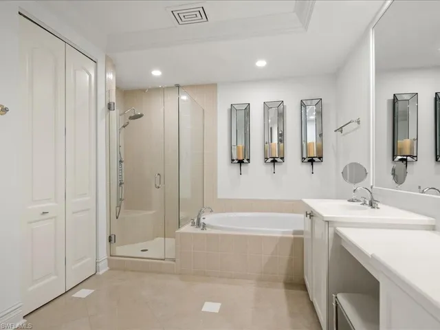 Bathroom with a bath, a stall shower, vanity, and recessed lighting