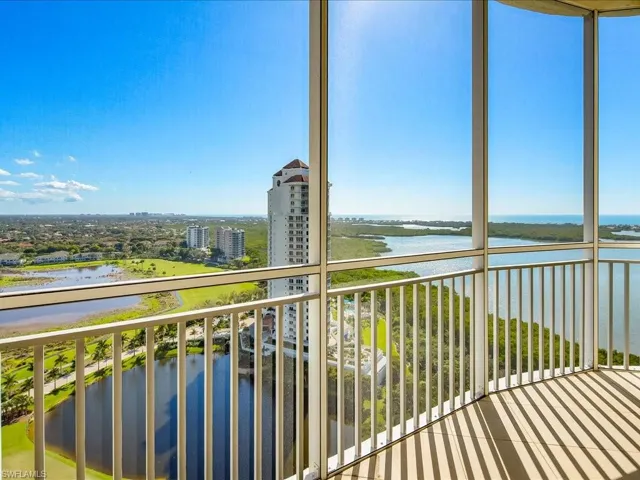 Balcony featuring a water view and a sunroom