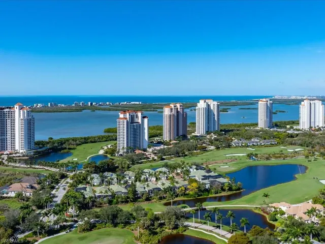 View of urban area featuring a nearby body of water and a golf course