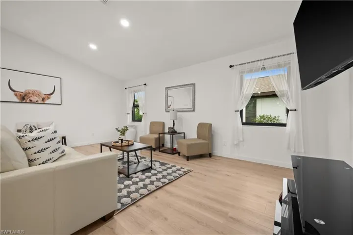 Living room featuring lofted ceiling and light wood-type flooring