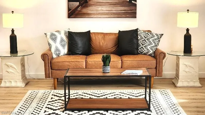 Living room with light hardwood / wood-style flooring