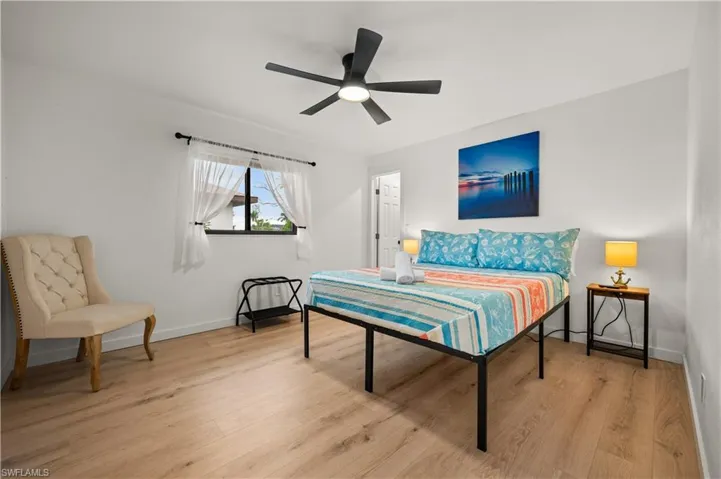 Bedroom with ceiling fan and light wood-type flooring