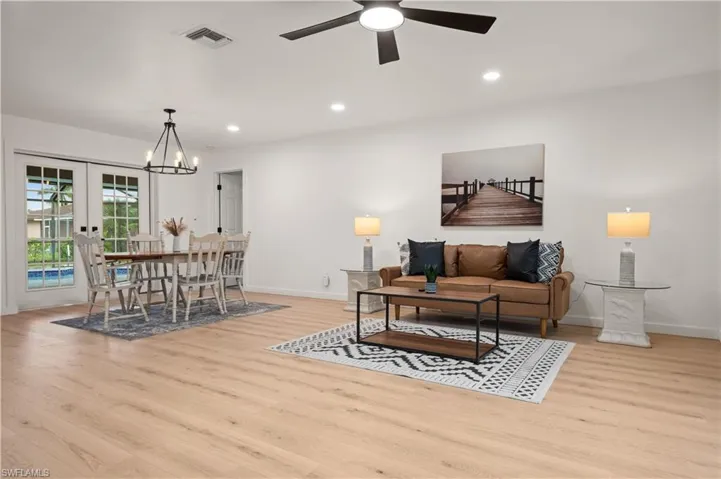 Living room featuring ceiling fan, light hardwood / wood-style floors, and french doors